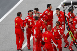 Ferrari team members celebrate the victory of Sebastian Vettel