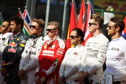 Nico Rosberg, Mercedes AMG F1 and Kimi Raikkonen, Ferrari as the grid observes the national anthem