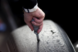 A Pirelli tyre technician checking tyre temperatures