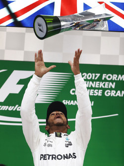 Lewis Hamilton, Mercedes AMG, celebrates taking victory on the podium