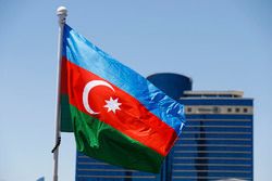 An Azerbaijan flag flies in front of the Hilton Hotel