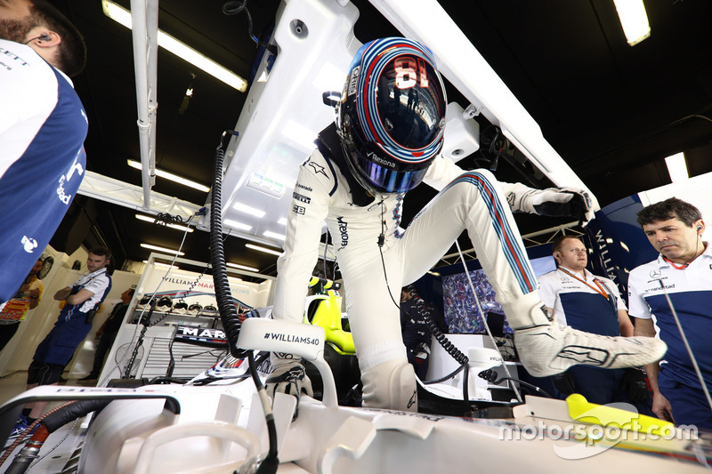 Lance Stroll, Williams, climbs in to his car