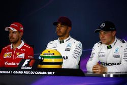 The post-qualifying press conference: Lewis Hamilton, Mercedes AMG F1, shows off his Ayrton Senna helmet, a gift after equalling the Brazilian's pole record, alongside Sebastian Vettel, Ferrari, Valtteri Bottas, Mercedes AMG F1