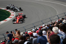 Kimi Raikkonen, Ferrari SF70H and Romain Grosjean, Haas F1 Team VF-17