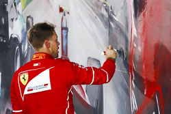 Sebastian Vettel, Ferrari, 1st Position, signs some artwork after winning