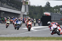 Riders leave the pits after tyre change