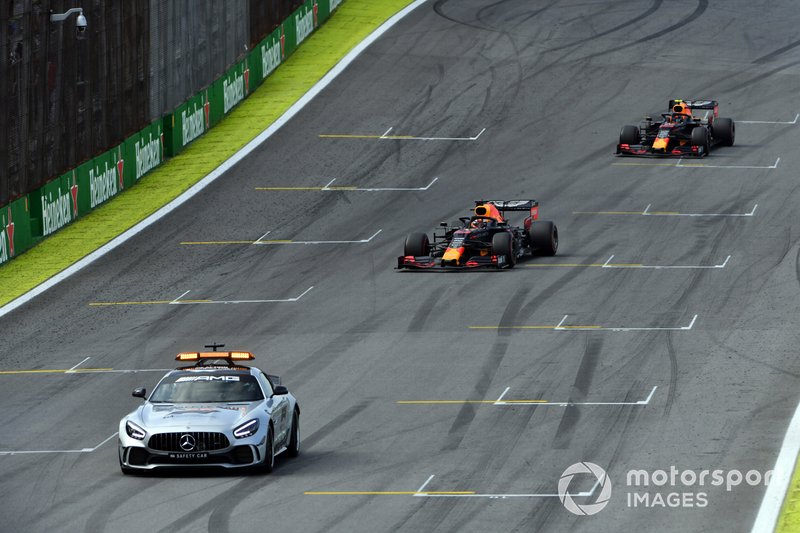 The Safety Car leads Max Verstappen, Red Bull Racing RB15, and Alexander Albon, Red Bull RB15