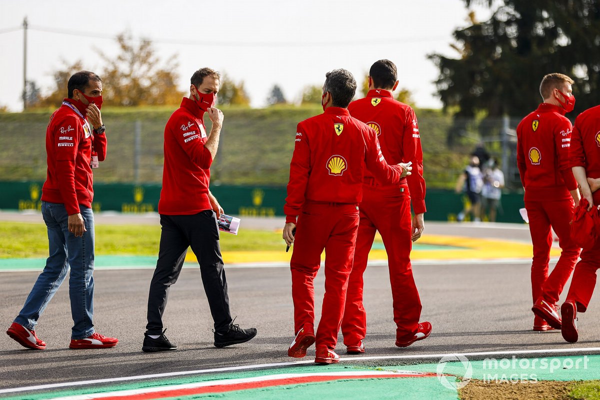 Sebastian Vettel, Ferrari, walks the track with Ferrari team mates