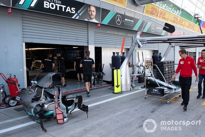 Sebastian Vettel, Ferrari walks past the Mercedes AMG F1 garage in the pit lane