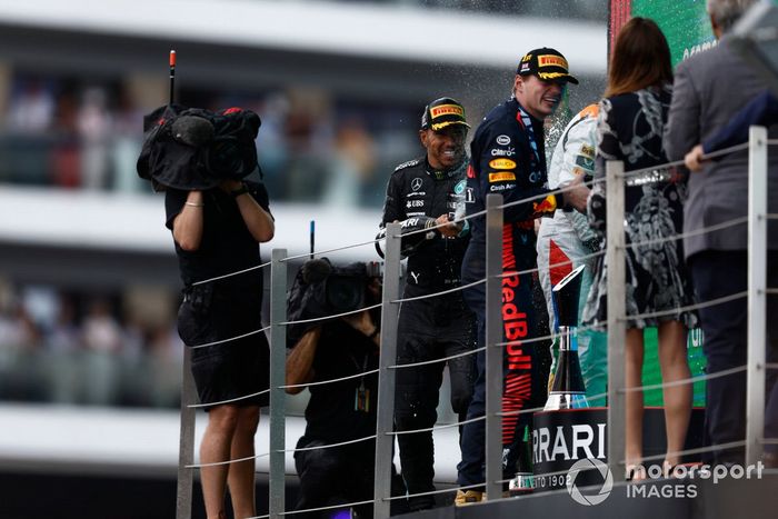 Lewis Hamilton, Mercedes-AMG, 3ª posición, Max Verstappen, Red Bull Racing, 1ª posición, rocía Champán en el podio.