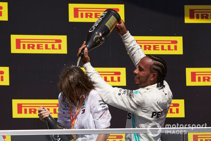 Lewis Hamilton, Mercedes AMG F1, 1st position, pours Champagne on his team mate on the podium