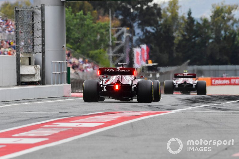 Antonio Giovinazzi, Alfa Romeo Racing C38, leads Kimi Raikkonen, Alfa Romeo Racing C38, in the pit lane