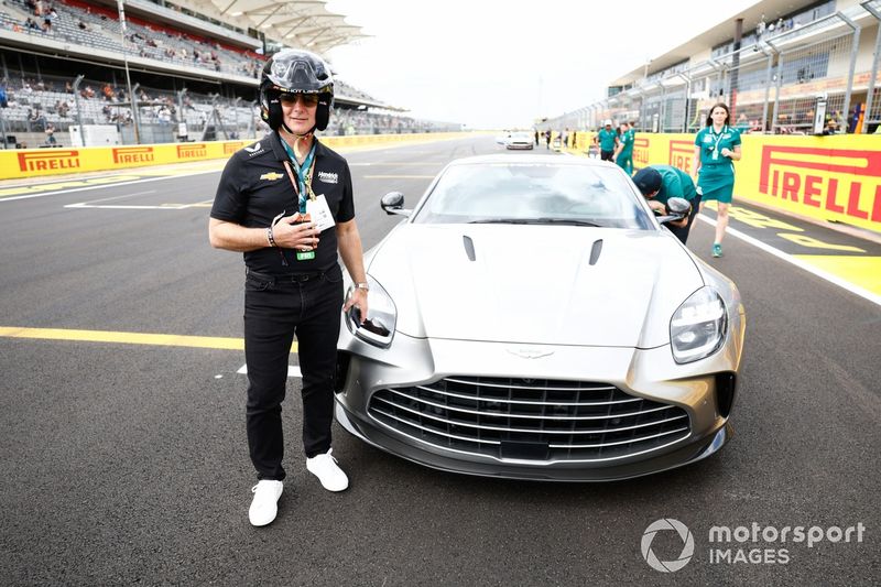 Former NASCAR star Jeff Gordon poses with an Aston Martin Pirelli Hot Laps car