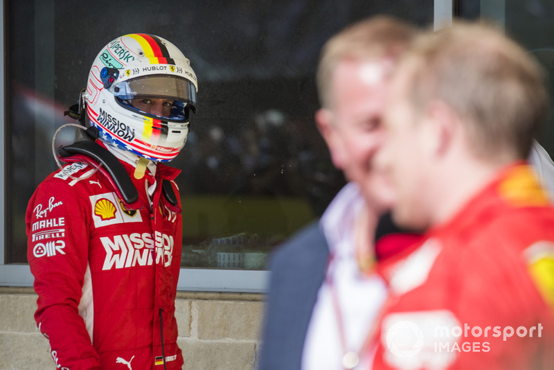 Sebastian Vettel, Ferrari, looks over as Kimi Raikkonen, Ferrari, 1st position, is interviewed by Martin Brundle, Sky Sports F1.