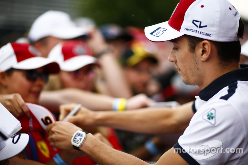 Charles Leclerc, Sauber, signs autographs for fans
