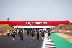 Kevin Magnussen, Haas F1 Team, and colleagues walk the track