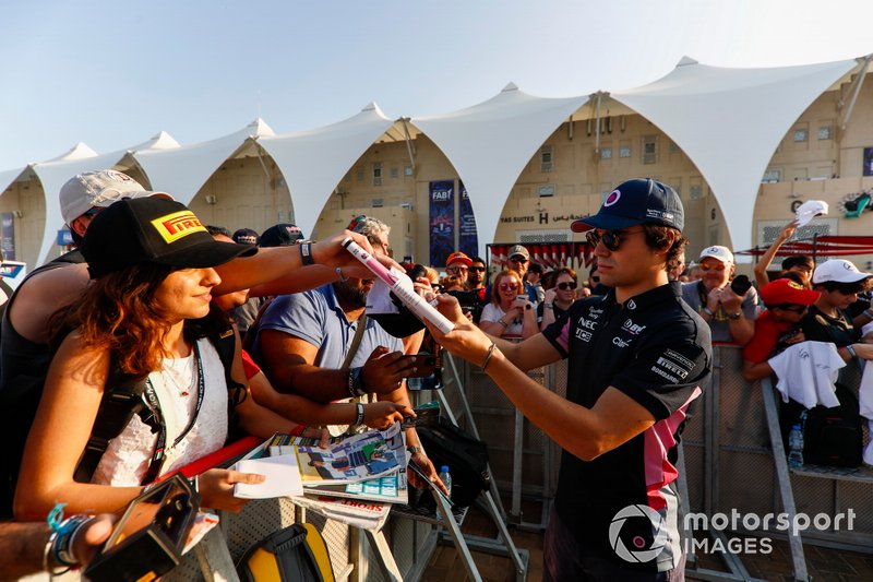 Lance Stroll, Racing Point, signs autographs for fans