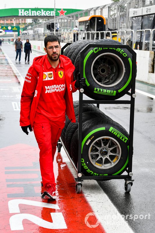 Ferrari mechanic with Pirelli tyres in the pit lane