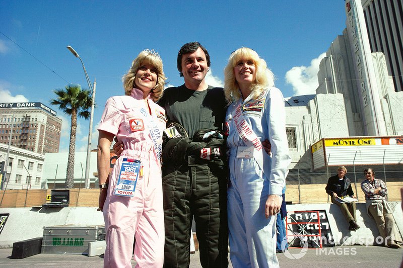 Alan Jones with two 'Miss Toyota Grand Prix'