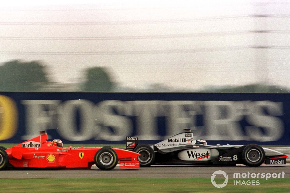 Michael Schumacher, Ferrari F300 overtakes Mika Hakkinen, McLaren MP4/13 Mercedes-Benz