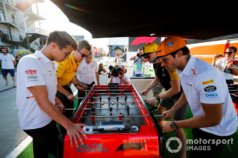 Lando Norris, McLaren, Carlos Sainz Jr., McLaren and Nico Hulkenberg, Renault F1 Team play table football in the paddock