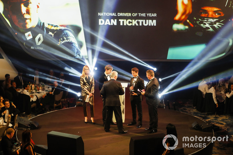 Williams F1 Driver George Russell, and McLaren F1 driver Lando Norris on stage to present the National Racing Driver Award to Dan Ticktum, accepted on his behalf by Derek Warwick