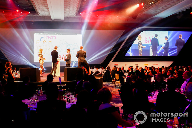Williams F1 Driver George Russell, and McLaren F1 driver Lando Norris on stage with hosts Nicki Shields and David Croft
