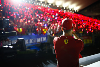 Sebastian Vettel, Ferrari, takes a photo of the gathered fans
