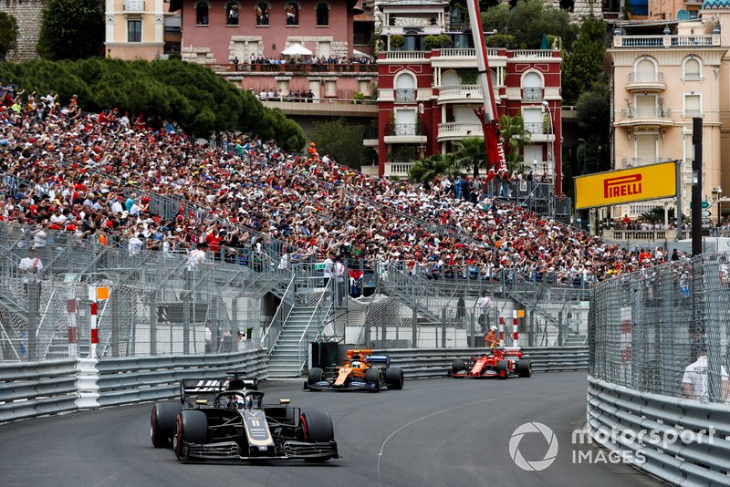 Romain Grosjean, Haas F1 Team VF-19, leads Lando Norris, McLaren MCL34