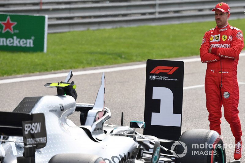 Sebastian Vettel, Ferrari, inspects the Mercedes AMG F1 W10 of his rivals