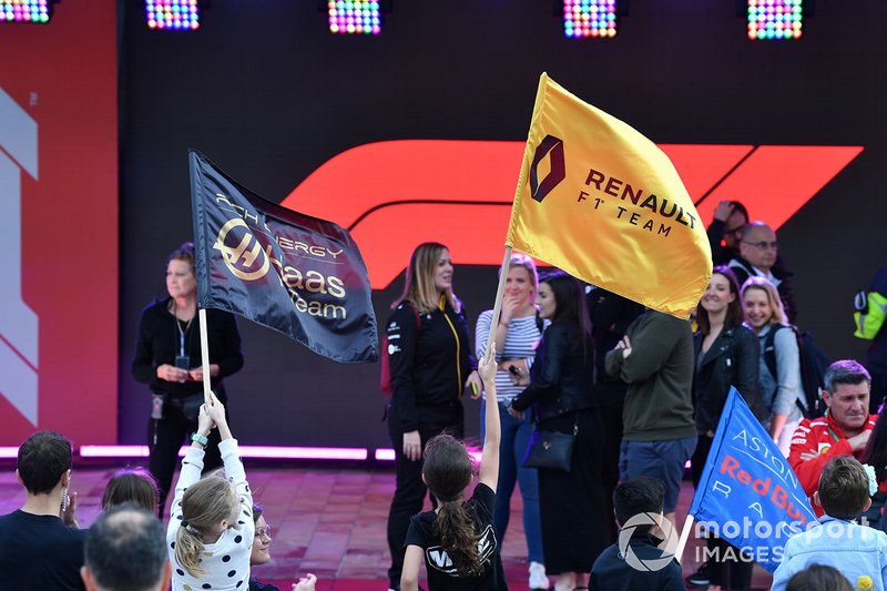 Haas and Renault flags are waved at the Federation Square fan event
