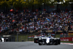Felipe Massa, Williams FW38, leads Romain Grosjean, Haas VF-16