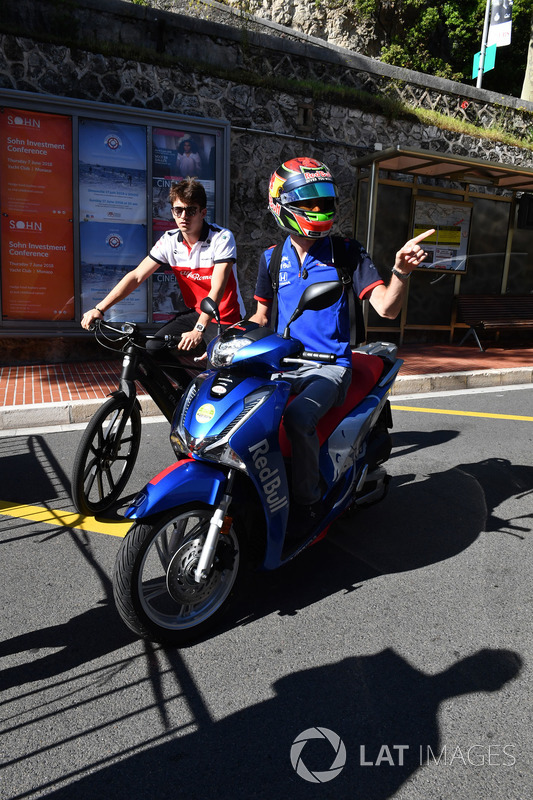 Charles Leclerc, Sauber on a bike and Brendon Hartley, Scuderia Toro Rosso on a scooter