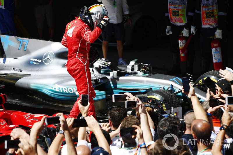 Sebastian Vettel, Ferrari SF70H, celebrates as he climbs from his car after winning the race