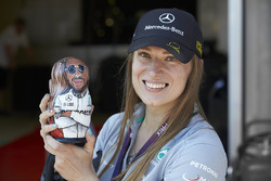 A Mercedes fan holds a Lewis Hamilton matryoshka figurine doll