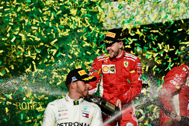 Lewis Hamilton, Mercedes-AMG F1 and Sebastian Vettel, Ferrari celebrate on the podium with the champ