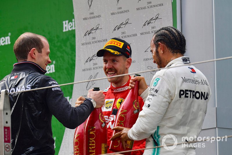Sebastian Vettel, Ferrari, 3rd position, and Lewis Hamilton, Mercedes AMG F1, 1st position, on the podium