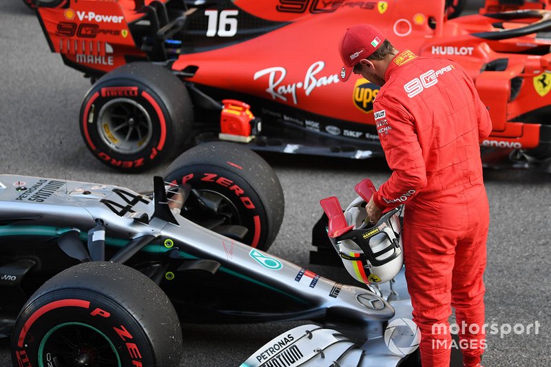 Sebastian Vettel, Ferrari, looks at the car of rival Lewis Hamilton, Mercedes AMG F1 W10, on the grid after Qualifying