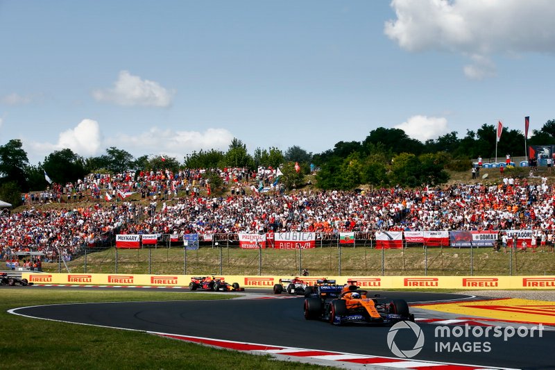 Carlos Sainz Jr., McLaren MCL34, leads Lando Norris, McLaren MCL34, Kimi Raikkonen, Alfa Romeo Racing C38, and Pierre Gasly, Red Bull Racing RB15