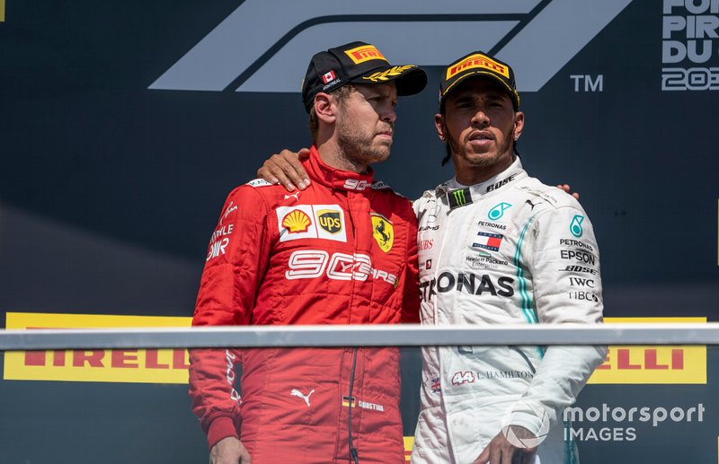 Sebastian Vettel, Ferrari, 2nd position, and Lewis Hamilton, Mercedes AMG F1, 1st position, on the podium