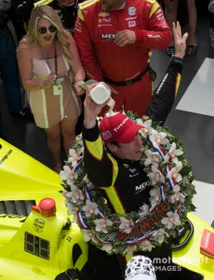 Simon Pagenaud, Team Penske Chevrolet, pours milk over his head in victory lane