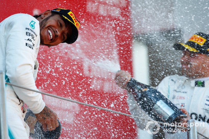 Lewis Hamilton, Mercedes AMG F1, 1st position, is blasted with Champagne by Valtteri Bottas, Mercedes AMG F1, 2nd position, on the podium