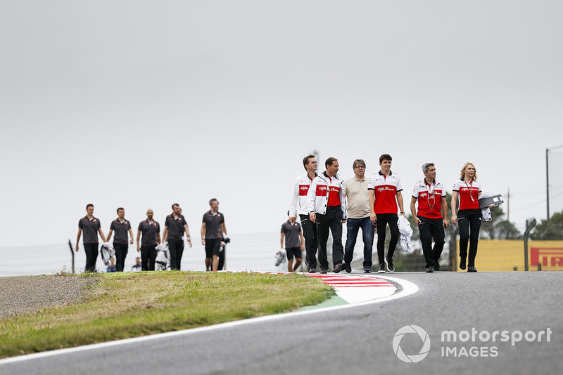 Charles Leclerc, Sauber, walks the track with his team.