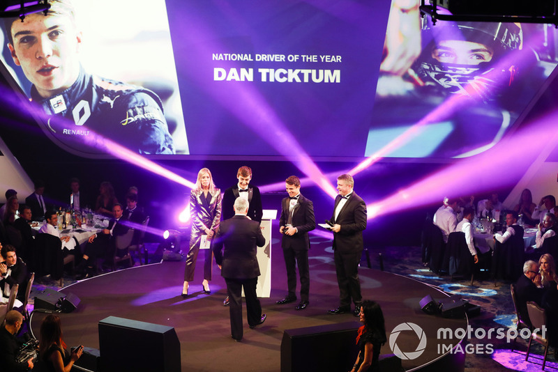 Williams F1 Driver George Russell, and McLaren F1 driver Lando Norris on stage to present the National Racing Driver Award to Dan Ticktum, accepted on his behalf by Derek Warwick