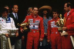 Ayrton Senna, McLaren Honda, 1st position, Alain Prost, McLaren Honda, 2nd position and Stefano Modena, Brabham BT58 Judd, 3rd position celebrate on the podium. McLaren team boss Ron Dennis on the far right