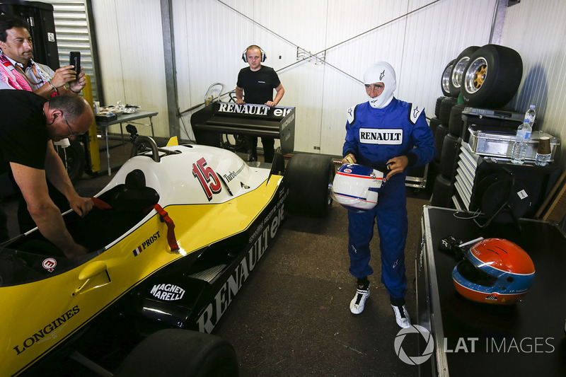 Alain Prost puts on his helmet before driving the Renault Sport F1 Team RE40