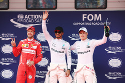 Lewis Hamilton, Mercedes AMG, celebrates taking pole position alongside Sebastian Vettel, Ferrari and Valtteri Bottas, Mercedes AMG