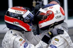 Rubens Barrichello, celebrates with Johnny Herbert, in Parc Ferme