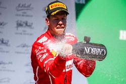 Race winner Sebastian Vettel, Ferrari, sprays Champagne from the podium