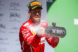 Race winner Sebastian Vettel, Ferrari, sprays Champagne from the podium